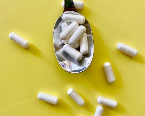 white medication pill on green and black bottle